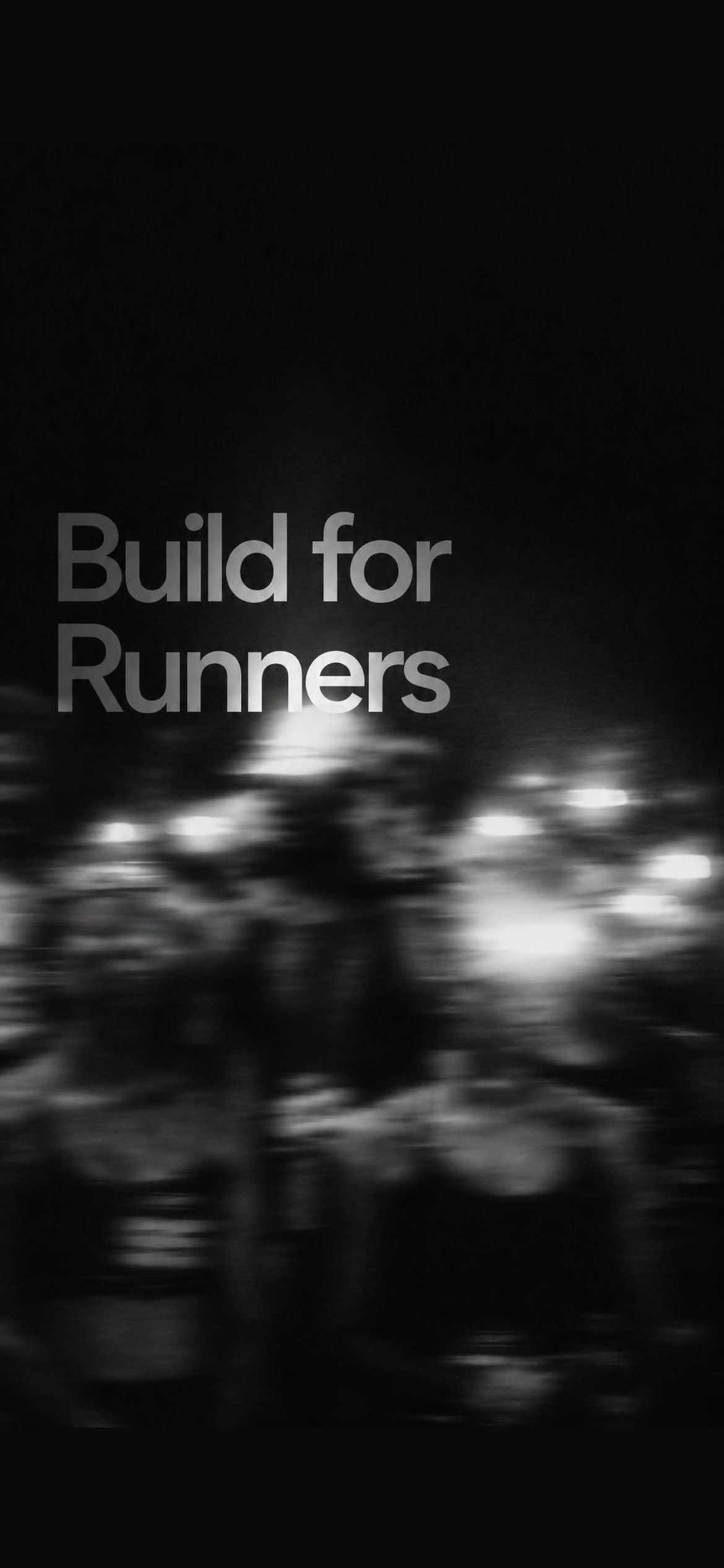 Motion-blurred runners training at night, with the words Built for Runners